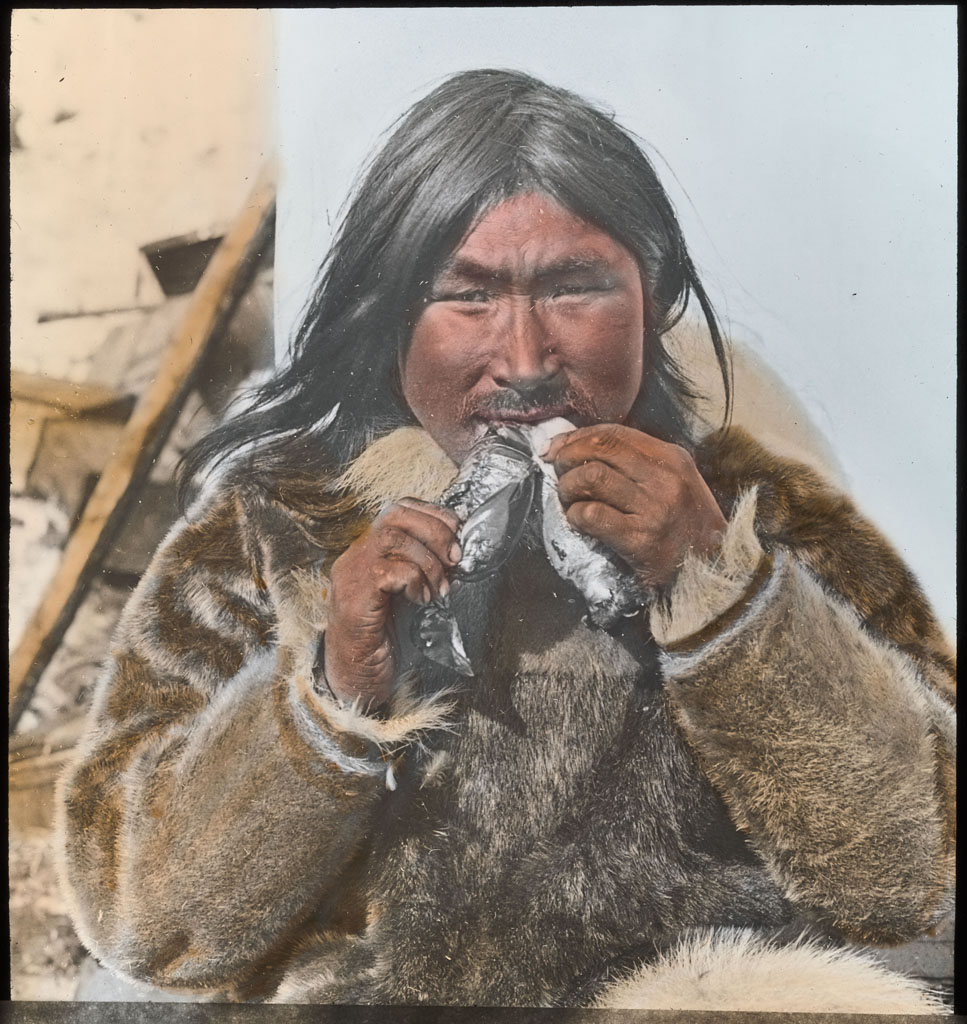 Donald Baxter MacMillan; Eskimo eating 2 Dovekies; 1913-1917; image; silver gelatin on glass; 10.16 cm x 8.26 cm x 0.64 cm (4 in. x 3 1/4 in. x 1/4 in.); TGM; North AmericaDonald Baxter MacMillan; Eskimo eating 2 Dovekies; 1913-1917; image; silver gelatin on glass; 10.16 cm x 8.26 cm x 0.64 cm (4 in. x 3 1/4 in. x 1/4 in.); TGM; North America