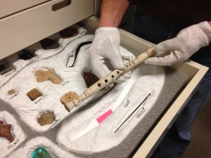 Associate Curator of Ancient Art, Jim Higginbotham, pulls out a Roman flute from the 1st or 2nd century.