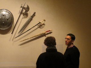 Students discuss a display of swords in The Object Show